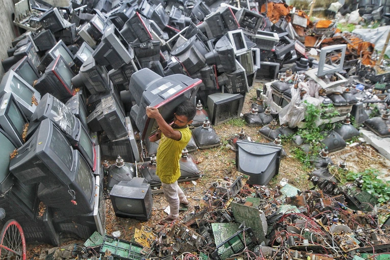 A man Disposing e-waste in the recycling center