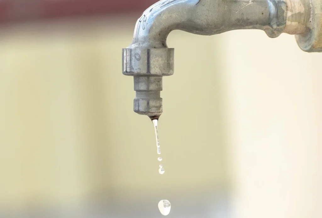 A drop of water falling from the kitchen resembling why we need for water conservation to save earth