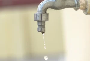 A drop of water falling from the kitchen resembling why we need for water conservation