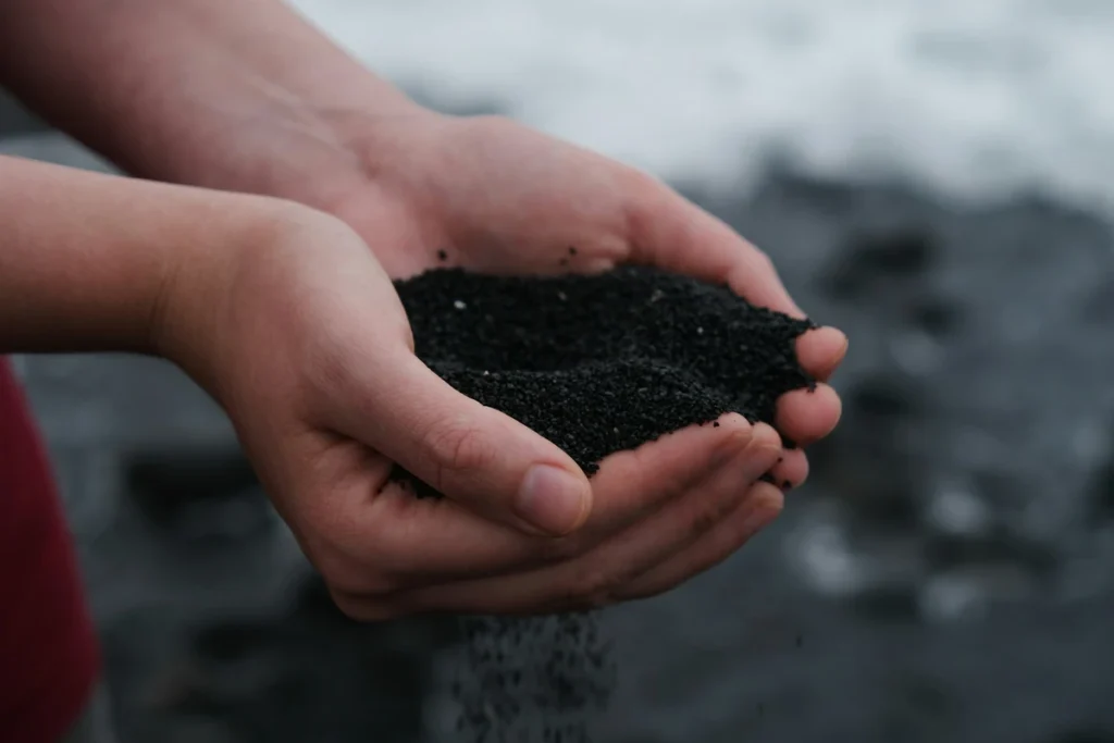 Hand full of compost made from kitchen waste.